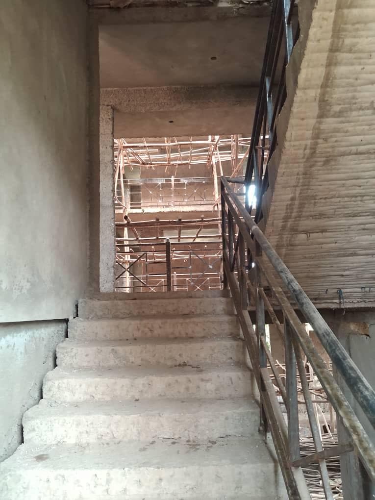 Concrete staircase with a metal handrail inside the hospital